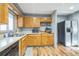 Kitchen features wood cabinets, stainless steel appliances, and wood-look flooring at 13413 W 21St Ave, Golden, CO 80401