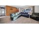 Living room with wood-paneled wall and comfortable seating at 13413 W 21St Ave, Golden, CO 80401