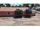 Pink building for lease with trees and parking lot at 480 N 6Th Ave, Brighton, CO 80601