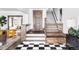 Bright entryway with checkerboard floor, wooden staircase, and built-in bench at 1465 Cook St, Denver, CO 80206