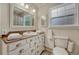 Bathroom with white vanity, wooden countertop, and tiled shower at 8311 S Mariposa Dr, Morrison, CO 80465