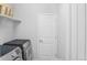 Convenient laundry room with washer, dryer, and additional shelving at 15373 E 113Th Pl, Commerce City, CO 80022