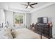 Large bedroom with a TV, dresser, and plenty of natural light at 15373 E 113Th Pl, Commerce City, CO 80022