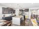 Modern kitchen with dark cabinets, granite counters, and an island at 15373 E 113Th Pl, Commerce City, CO 80022