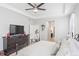 Primary bedroom with TV, dresser, and access to en-suite bathroom at 15373 E 113Th Pl, Commerce City, CO 80022