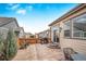 Spacious backyard patio with grill and seating area, ideal for outdoor living at 15373 E 113Th Pl, Commerce City, CO 80022