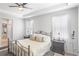 Bright bedroom with king bed, en-suite bathroom access, and ceiling fan at 15373 E 113Th Pl, Commerce City, CO 80022