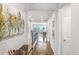 Bright hallway with hardwood floors and views to the living room at 15373 E 113Th Pl, Commerce City, CO 80022