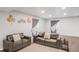 Finished basement Gathering room featuring comfortable seating and large windows at 15373 E 113Th Pl, Commerce City, CO 80022