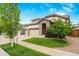 Two-story house with stone accents and a three-car garage at 15373 E 113Th Pl, Commerce City, CO 80022