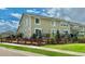 Tan two-story house with a wooden fence and small trees at 14595 Vancouver Pl, Parker, CO 80134