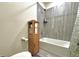 Simple bathroom with shower/tub combo and wood storage cabinet at 14595 Vancouver Pl, Parker, CO 80134