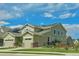 Two-story house with solar panels, landscaped yard, and attached garage at 14595 Vancouver Pl, Parker, CO 80134