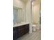 Modern bathroom with dark brown vanity and tile floor at 14595 Vancouver Pl, Parker, CO 80134