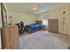 Cozy bedroom with a bed, dresser, and chair at 14595 Vancouver Pl, Parker, CO 80134