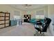 Well-lit bedroom with a desk, comfortable seating, and storage at 14595 Vancouver Pl, Parker, CO 80134