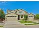 Two-story house with three car garage and landscaped yard at 14595 Vancouver Pl, Parker, CO 80134