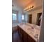 Main bathroom with double sinks and a large mirror at 2604 S Dunkirk Ct, Aurora, CO 80013