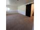 Spacious basement room with carpeted floor at 2604 S Dunkirk Ct, Aurora, CO 80013