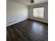 Bright bedroom with wood-look floors and a large window at 2604 S Dunkirk Ct, Aurora, CO 80013