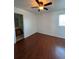 Bright bedroom with wood-look floors and ceiling fan at 2604 S Dunkirk Ct, Aurora, CO 80013