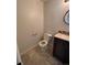 Small bathroom with dark vanity and tiled floor at 2604 S Dunkirk Ct, Aurora, CO 80013