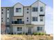 Modern two-story townhome with light brick exterior and balcony at 5675 Vivian St, Arvada, CO 80002