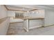 Basement bar with wood countertop and tile flooring at 1490 Saint Andrews Dr, Broomfield, CO 80020