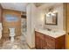 Rustic basement bathroom with wood-paneled walls and granite vanity at 1490 Saint Andrews Dr, Broomfield, CO 80020