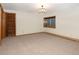 Spacious basement bedroom with neutral carpeting and chandelier at 1490 Saint Andrews Dr, Broomfield, CO 80020