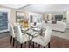 Bright dining area with glass table and seating for six, open to the living room at 1490 Saint Andrews Dr, Broomfield, CO 80020