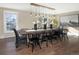 Farmhouse style dining room with a large wooden table and black chairs at 1490 Saint Andrews Dr, Broomfield, CO 80020