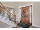 Bright entryway with hardwood floors, staircase, and wooden door at 1490 Saint Andrews Dr, Broomfield, CO 80020