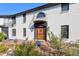 Elegant home entrance with a large wooden door and brick facade at 1490 Saint Andrews Dr, Broomfield, CO 80020
