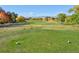 Scenic golf course view with fall foliage and mountains in the distance at 1490 Saint Andrews Dr, Broomfield, CO 80020
