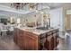 Open kitchen with large island, gas cooktop and custom cabinetry at 1490 Saint Andrews Dr, Broomfield, CO 80020