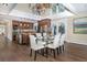 Open concept kitchen and dining area with granite island, stainless steel appliances, and hardwood floors at 1490 Saint Andrews Dr, Broomfield, CO 80020
