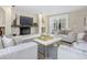 Living room featuring a cozy fireplace, built-in shelving, and ample natural light at 1490 Saint Andrews Dr, Broomfield, CO 80020
