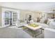 Bright living room with French doors leading to a sunroom and comfortable seating at 1490 Saint Andrews Dr, Broomfield, CO 80020