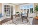 Home office with a glass desk, built in shelving and large windows at 1490 Saint Andrews Dr, Broomfield, CO 80020