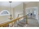 Elegant upstairs hall with chandelier and access to bedrooms at 1490 Saint Andrews Dr, Broomfield, CO 80020