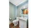 Powder room with a modern pedestal sink and soothing green walls at 19 South Rd, Breckenridge, CO 80424