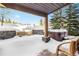Covered patio with hot tub and fire pit, perfect for relaxing at 19 South Rd, Breckenridge, CO 80424