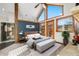 Main bedroom with large windows, high ceilings and ensuite bathroom at 19 South Rd, Breckenridge, CO 80424