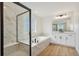 Elegant bathroom with marble shower, soaking tub, and modern vanity at 42980 Colonial Trl, Elizabeth, CO 80107