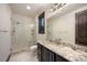 Bathroom with walk-in shower and granite countertop vanity at 11164 Beatrice Ct, Littleton, CO 80125