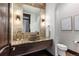 Modern powder room with stone vessel sink and wood vanity at 11164 Beatrice Ct, Littleton, CO 80125