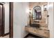 Elegant powder room with floating vanity and stone wall accents at 11164 Beatrice Ct, Littleton, CO 80125