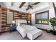 Spacious bedroom with wood-paneled accent wall and neutral decor at 11164 Beatrice Ct, Littleton, CO 80125