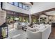 Open living room with hardwood floors, large windows, and access to the kitchen and patio at 11164 Beatrice Ct, Littleton, CO 80125